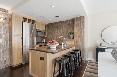 a kitchen with stainless steel appliances a refrigerator and a stove