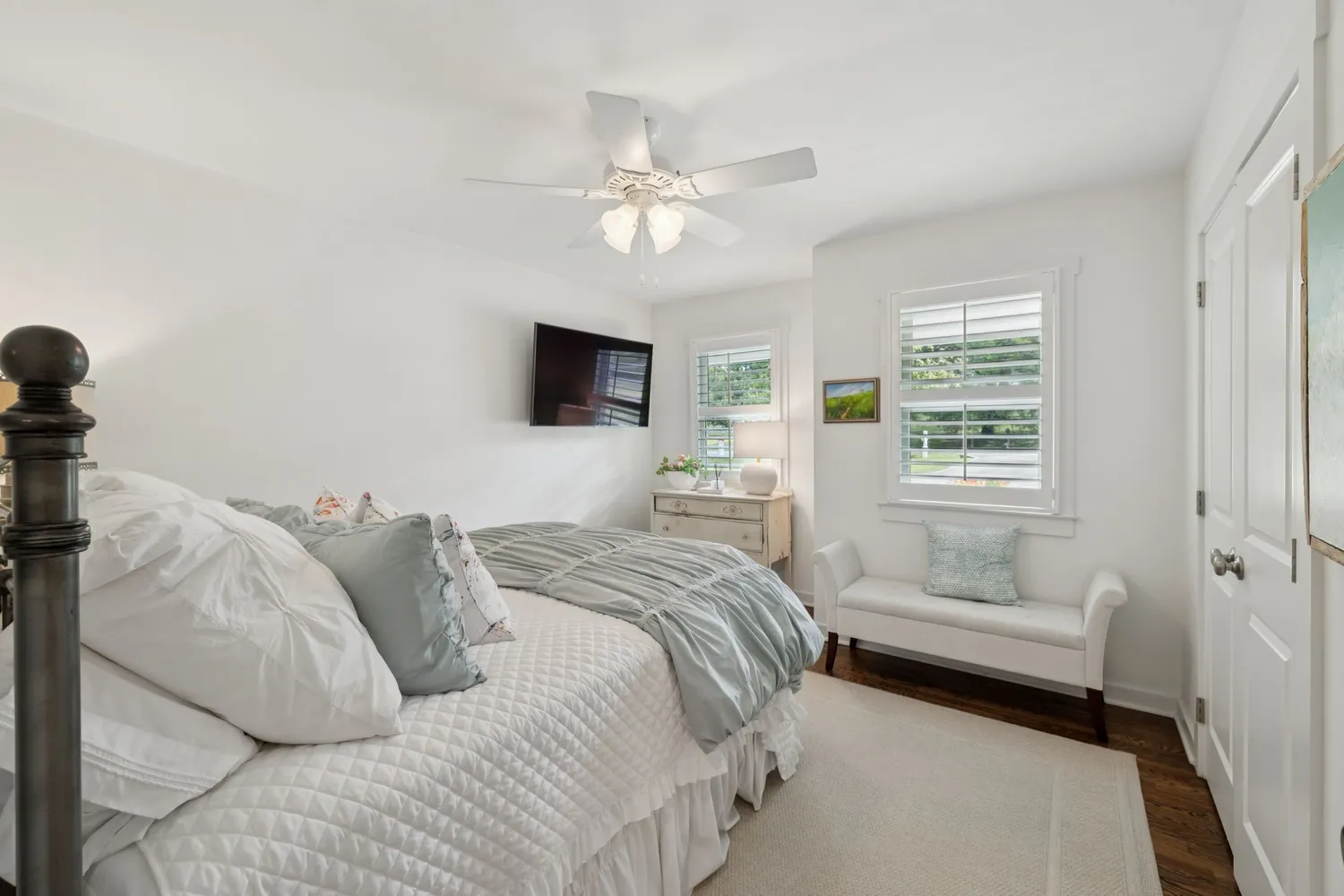 a bedroom with a bed and ceiling fan