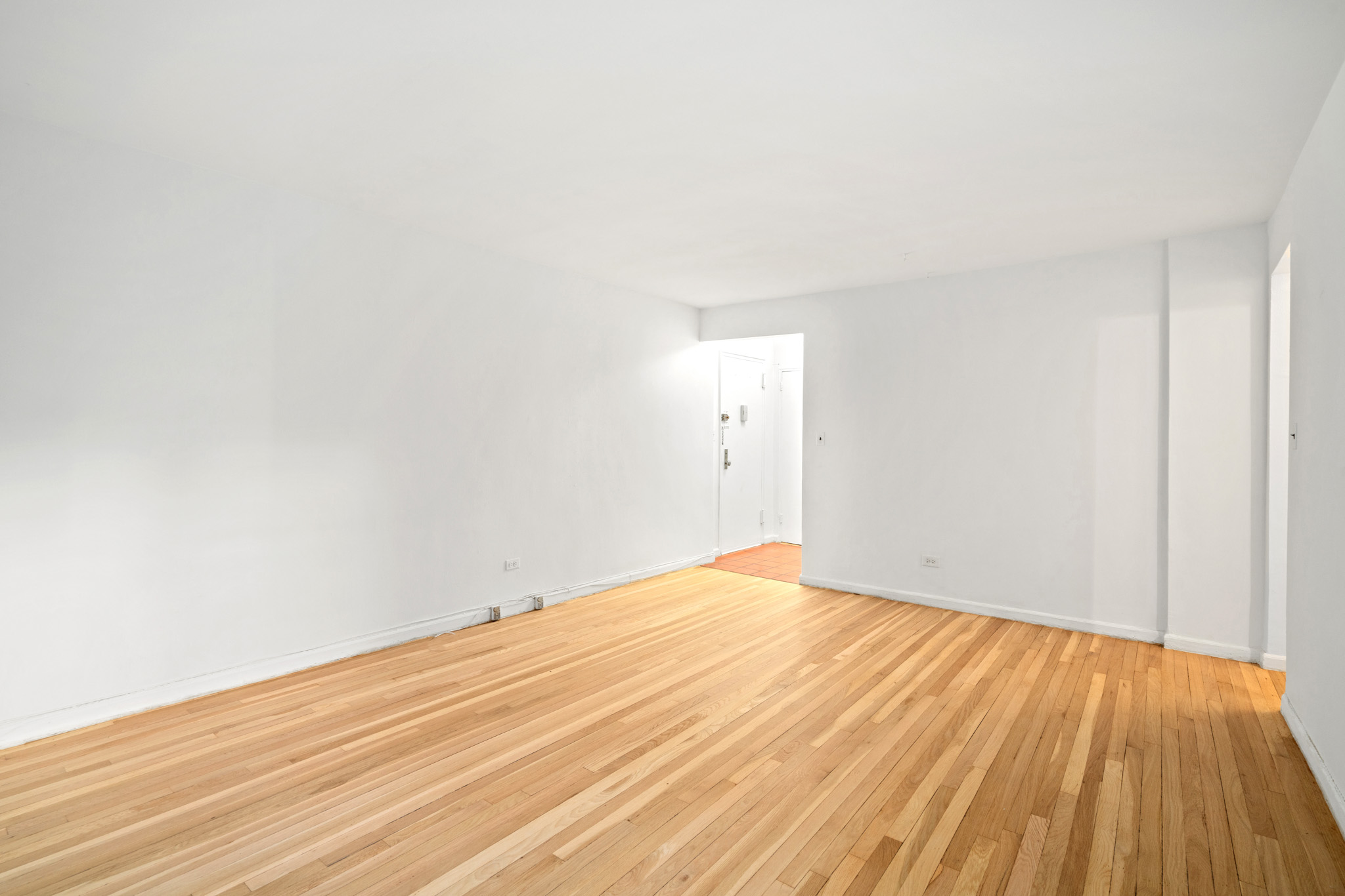 60 East 9th Street, Unit 235 Manhattan, NY 10003 - Photo 6 of 14 a view of empty room with wooden floor