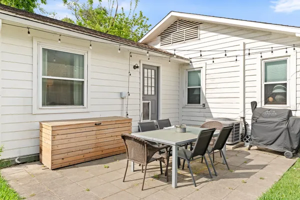 a view of a patio with table and chairs and wooden floor