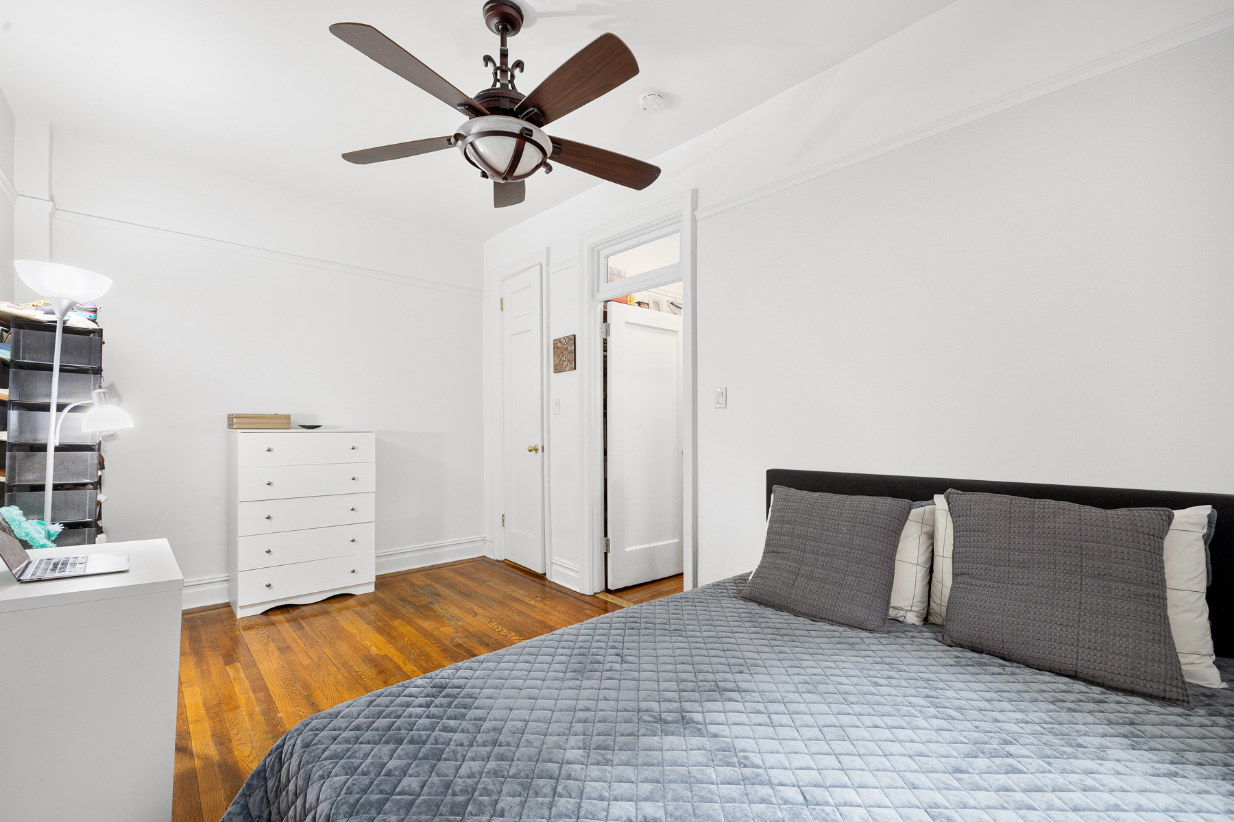 255 Eastern Parkway, Unit C5 Brooklyn, NY 11238 - Photo 6 of 9 a bedroom with a bed and a ceiling fan