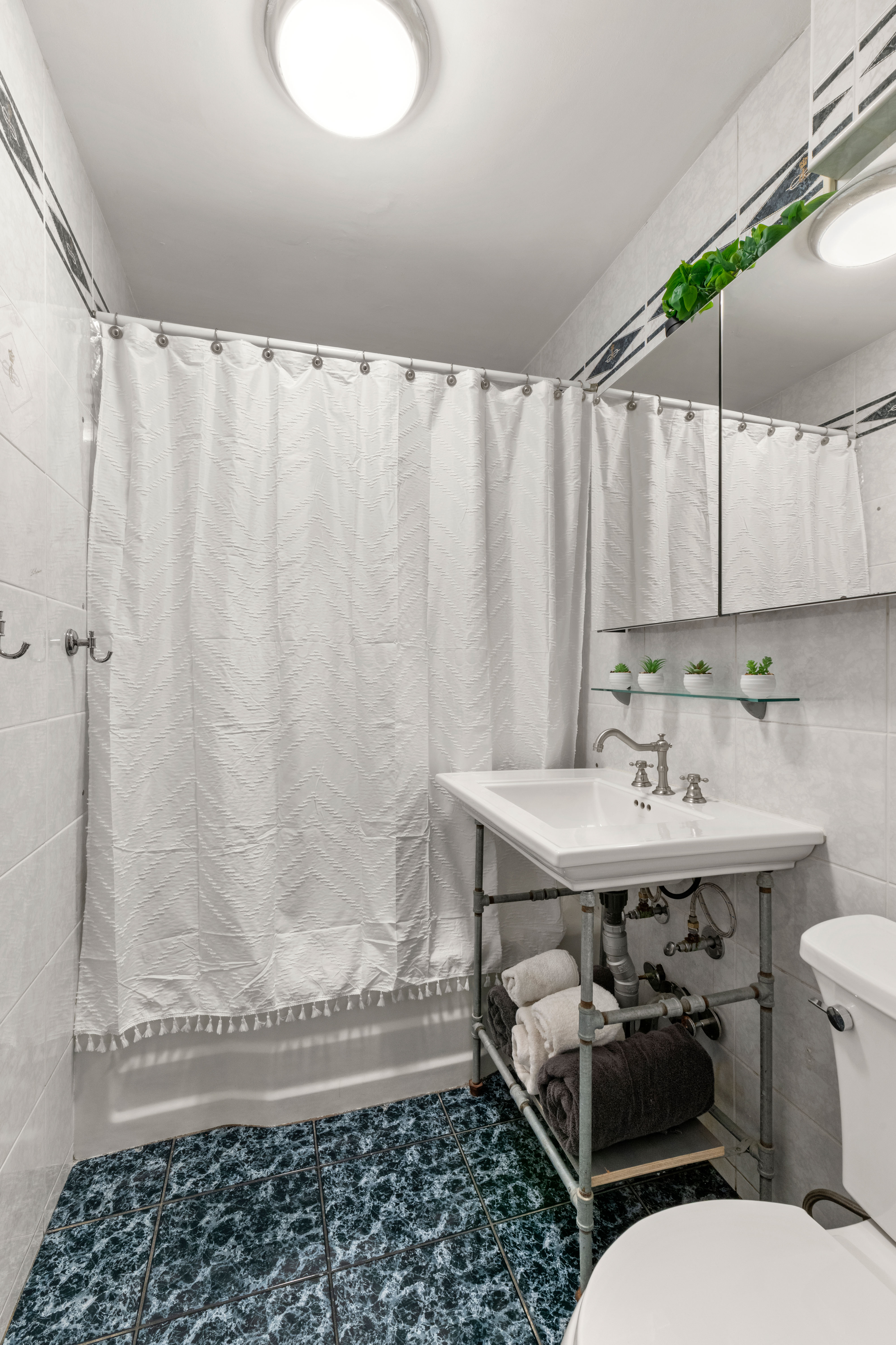 102-30 66th Road, Unit 7E Queens, NY 11375 - Photo 10 of 15 a bathroom with a sink and a toilet