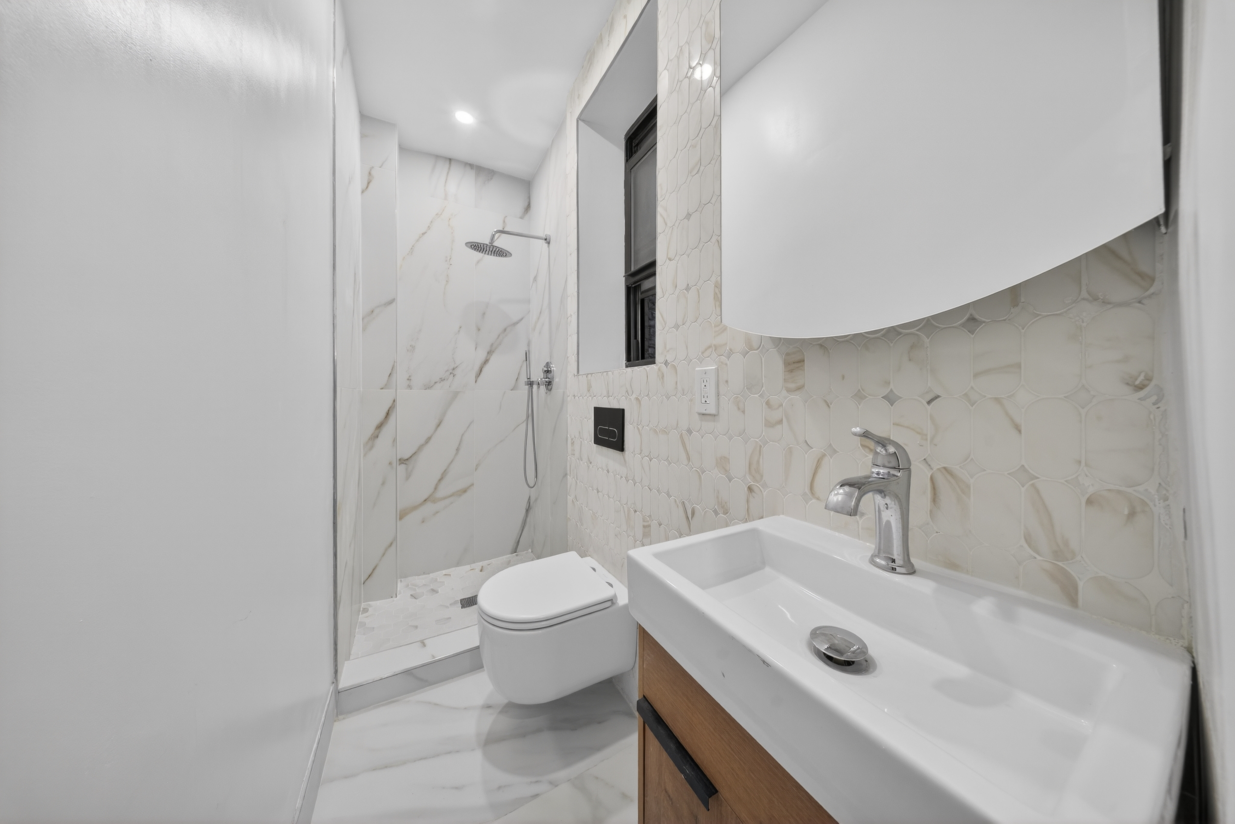 120 East 83rd Street, Unit 3D Manhattan, NY 10028 - Photo 5 of 8 a bathroom with a sink a toilet and shower