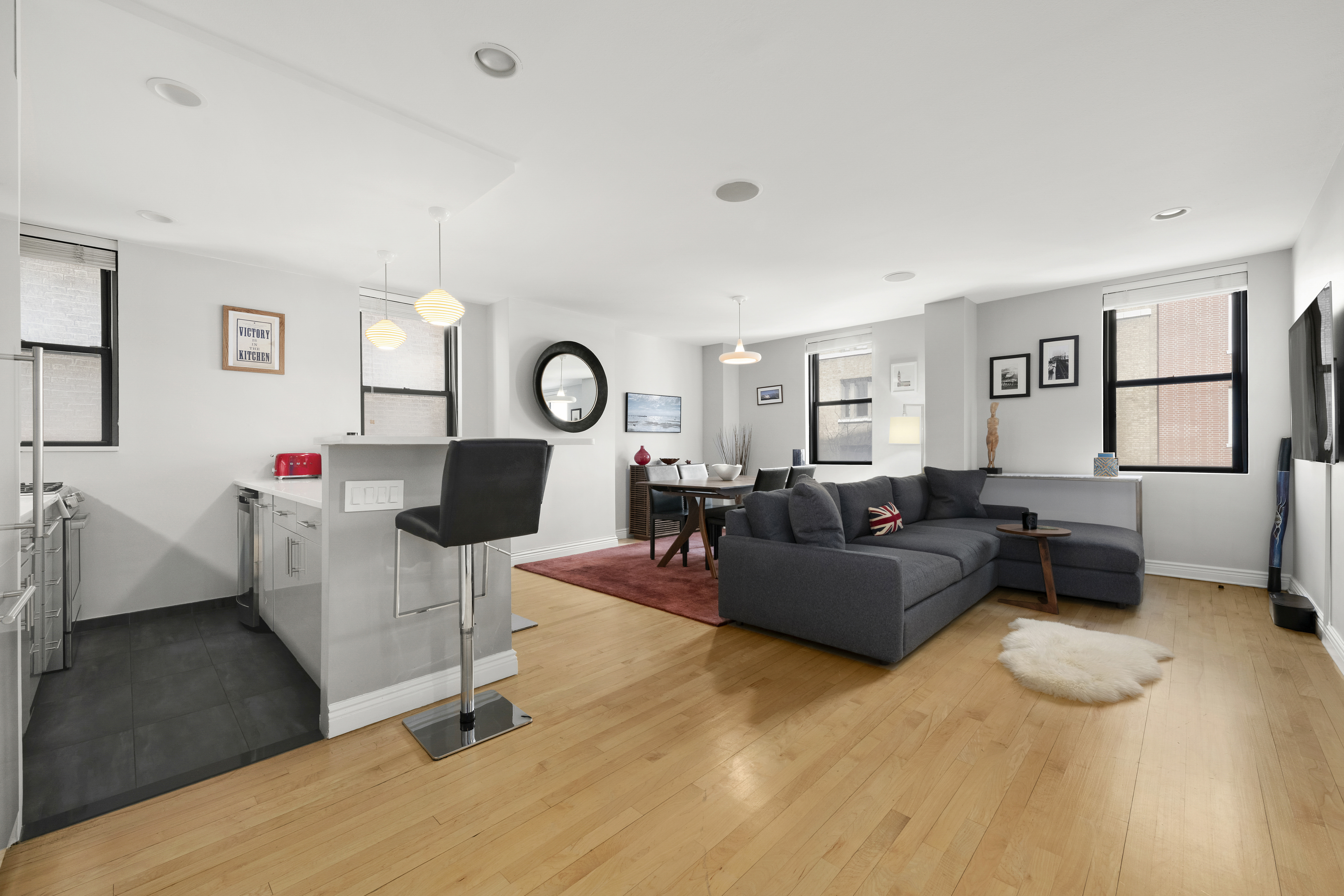 340 West 55th Street, Unit 5C Manhattan, NY 10019 - Photo 1 of 10 a living room with furniture and a large window
