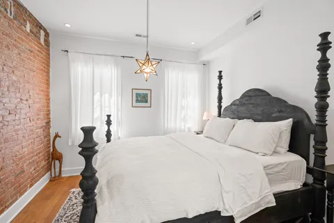 a bedroom with a bed and a chandelier