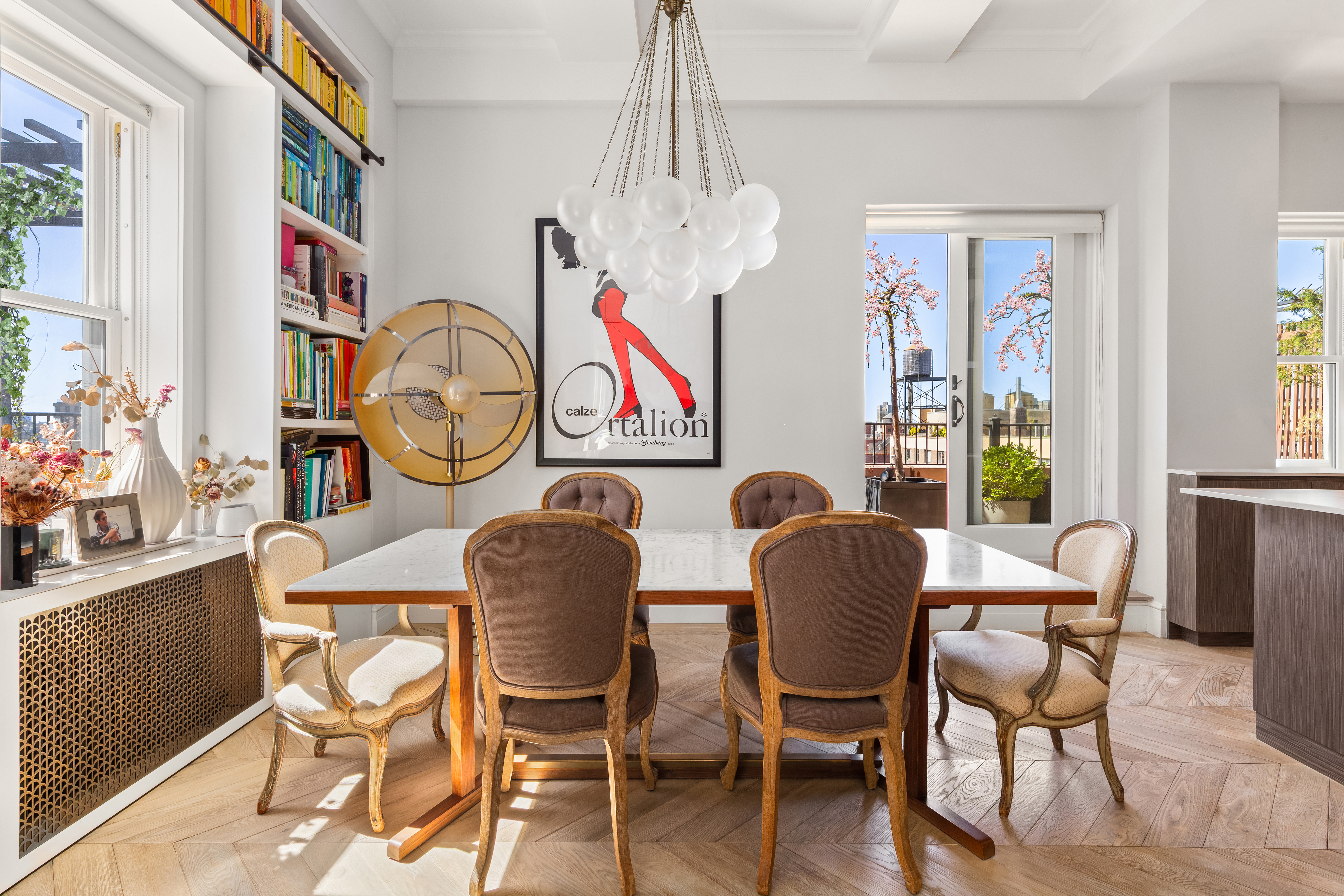 243 West End Avenue, Unit PH Manhattan, NY 10023 - Photo 2 of 11 a dining room with furniture a chandelier and wooden floor
