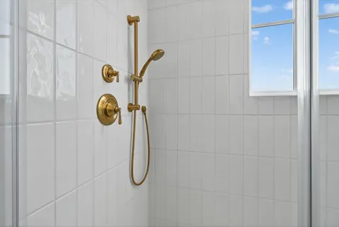 a bathroom with double vanity sinks a vanity a lamp and a mirror