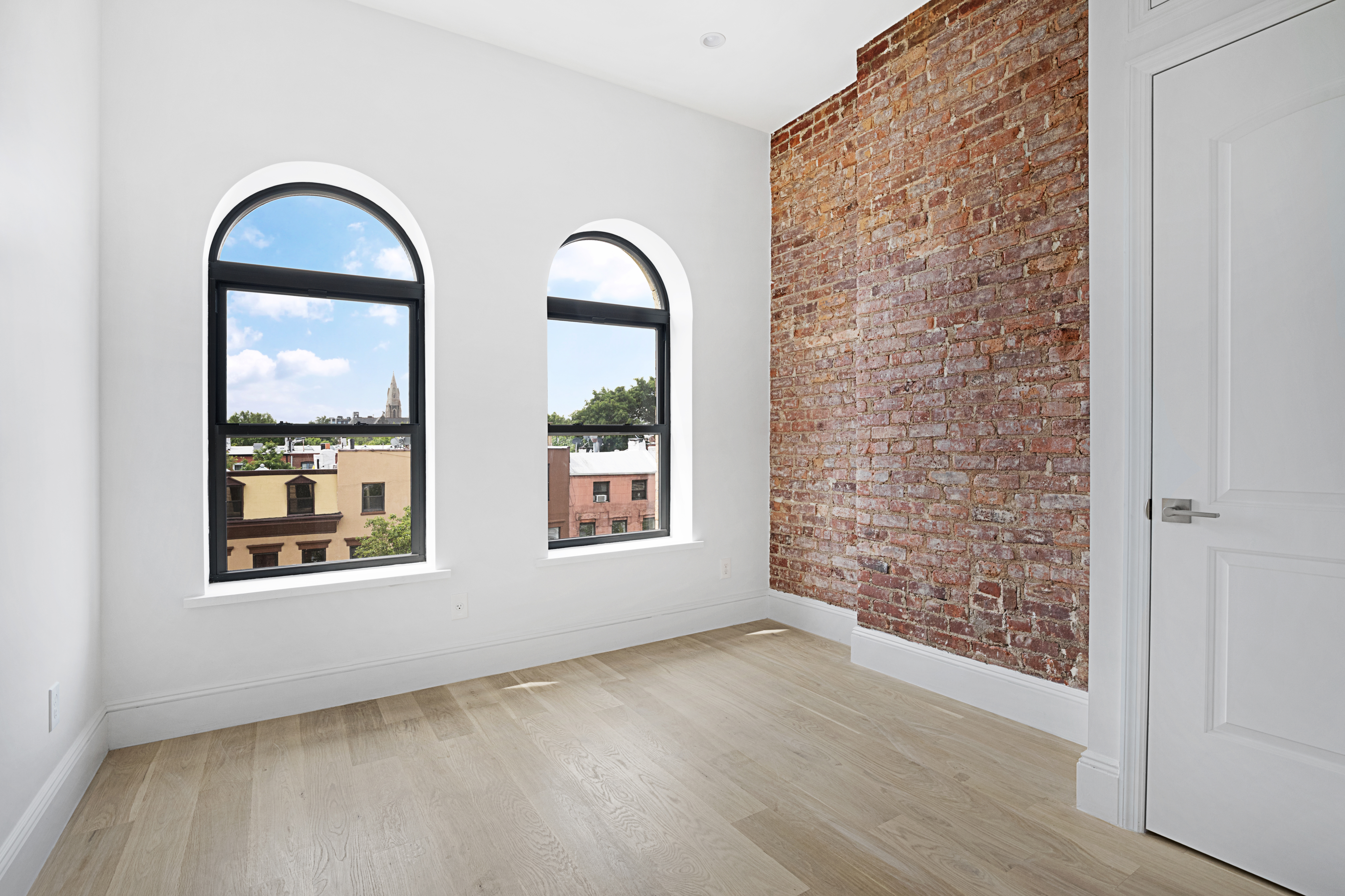 443 Jefferson Avenue, Unit 1L Brooklyn, NY 11221 - Photo 7 of 12 a view of an empty room with windows and wooden floor