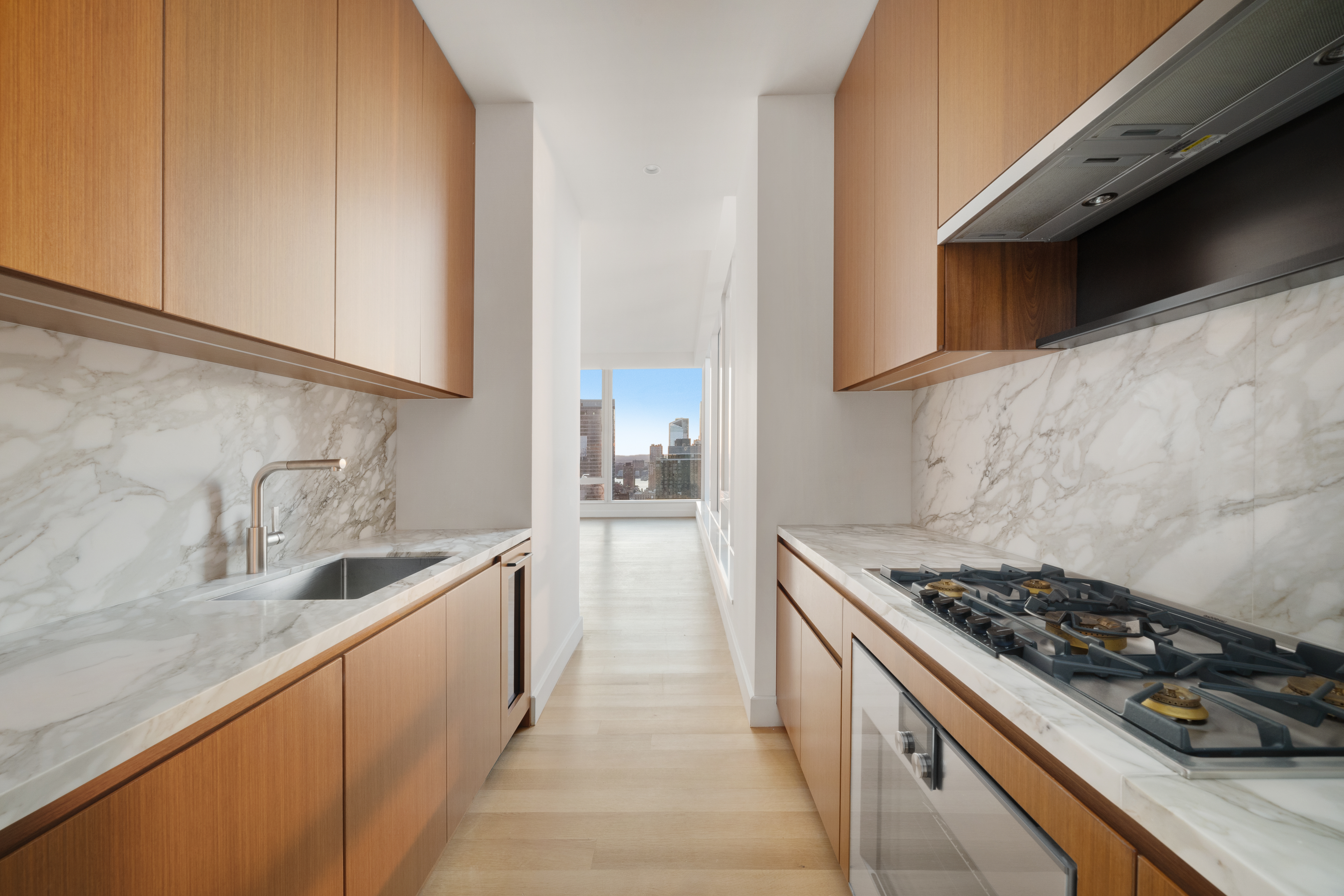 15 East 30th Street, Unit 42A Manhattan, NY 10016 - Photo 4 of 13 a kitchen with sink a stove and cabinets