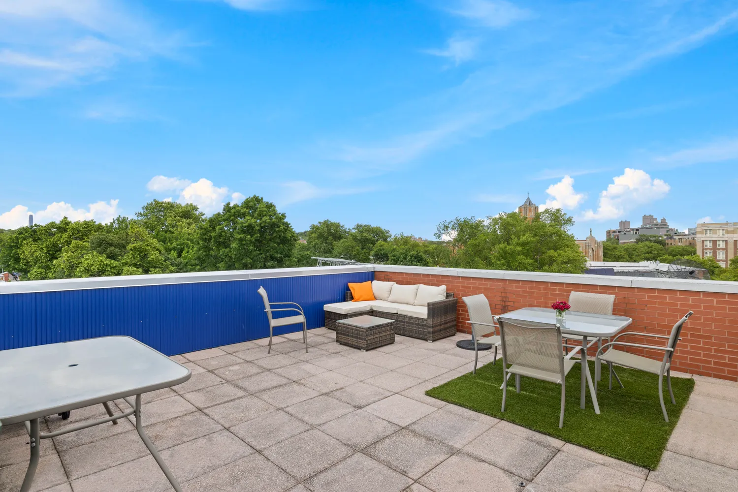 a view of a terrace with furniture and a yard