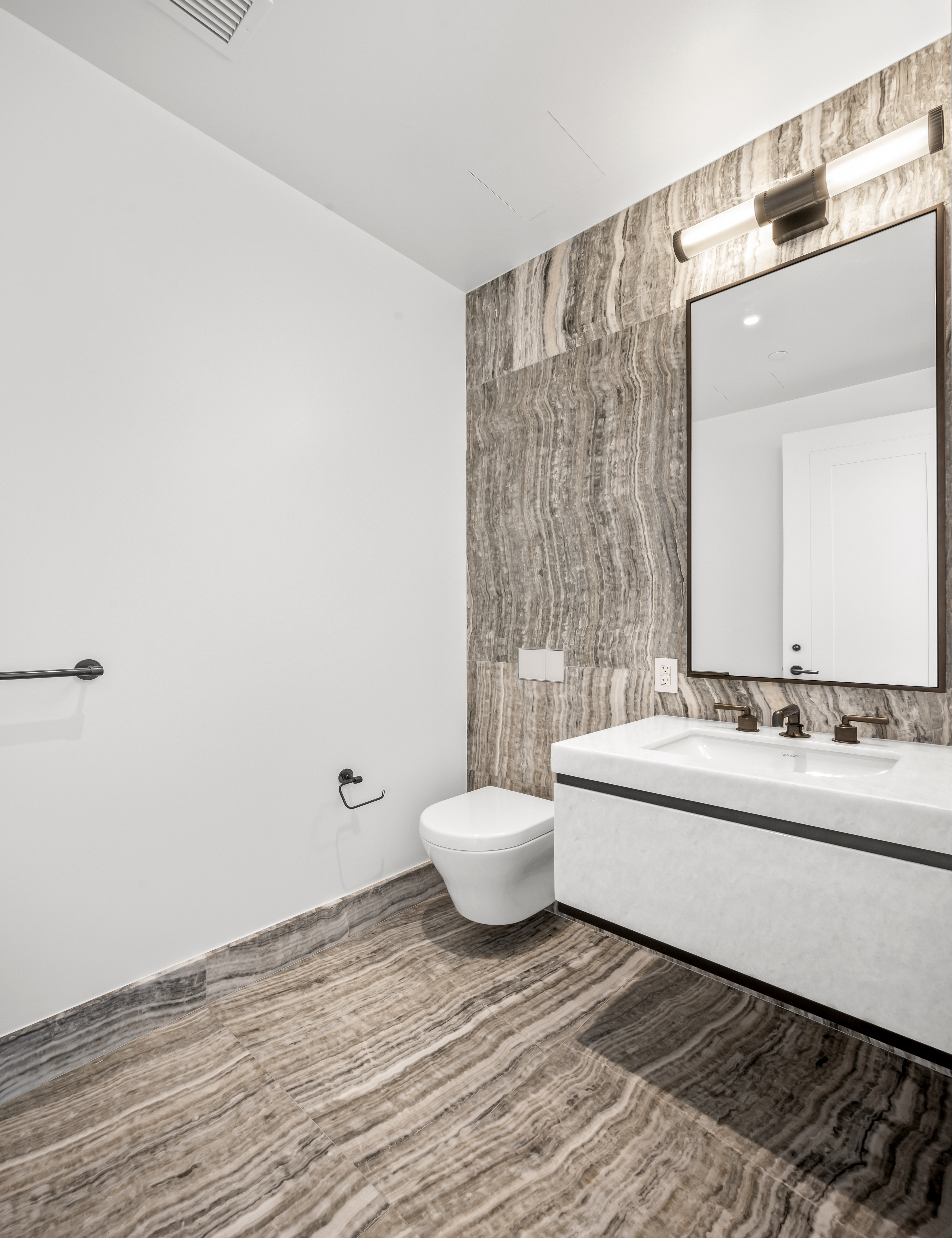 515 West 18th Street, Unit 1401 Manhattan, NY 10011 - Photo 11 of 12 a bathroom with a sink and a mirror