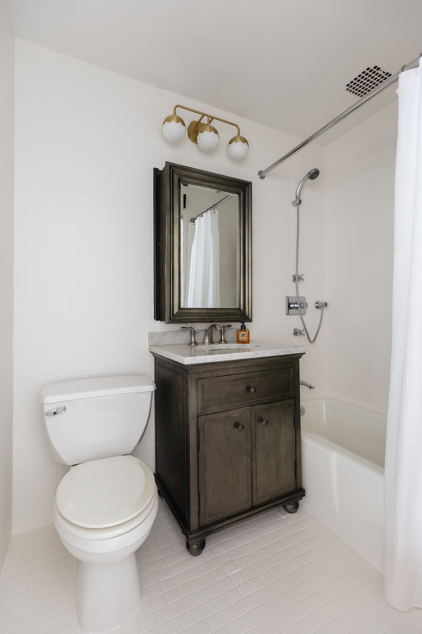9 Barrow Street, Unit 3H Manhattan, NY 10014 - Photo 6 of 9 a bathroom with a sink vanity mirror and toilet