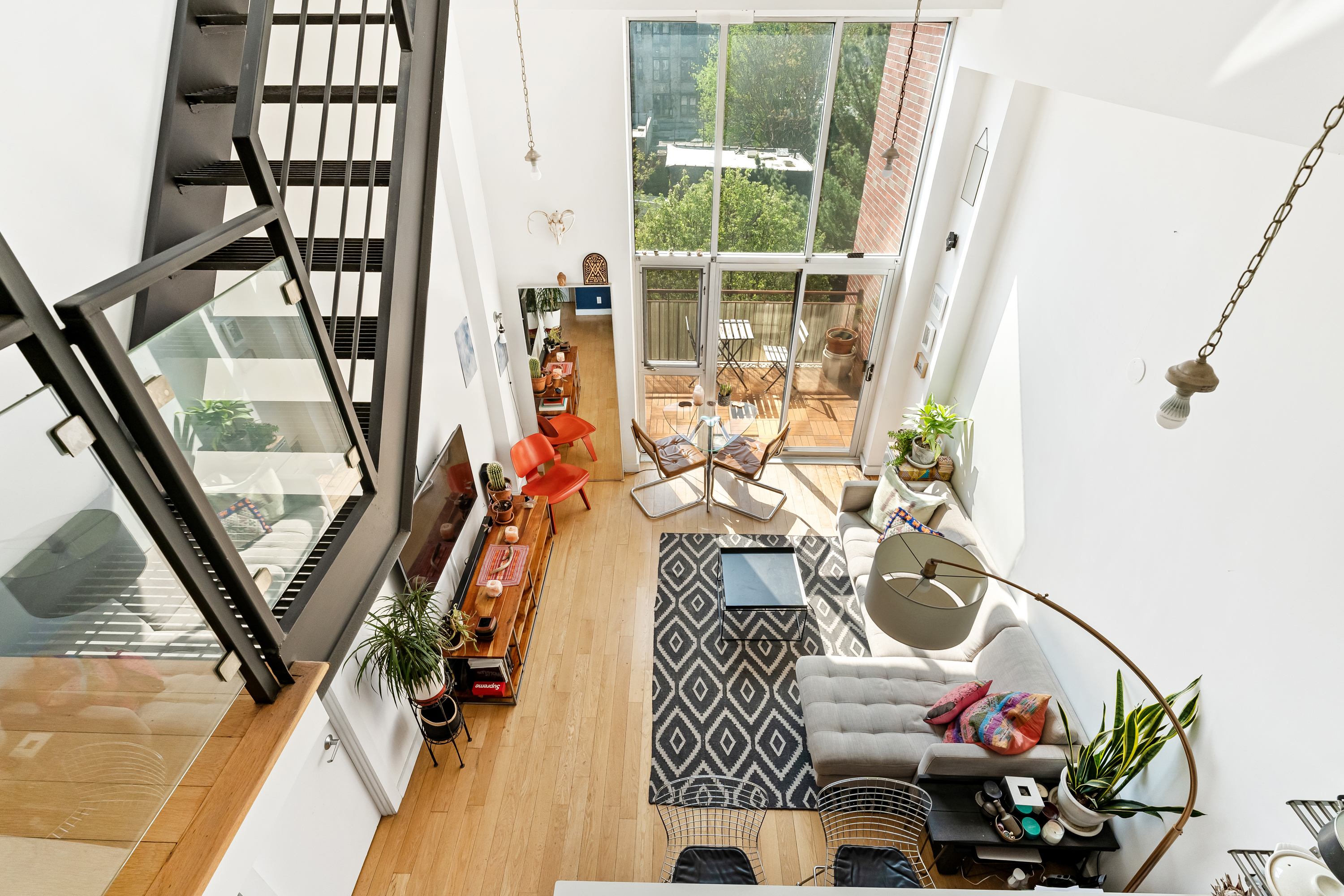 151 Manhattan Avenue, Unit 4B Brooklyn, NY 11206 - Photo 7 of 11 a living room with furniture and a floor to ceiling window