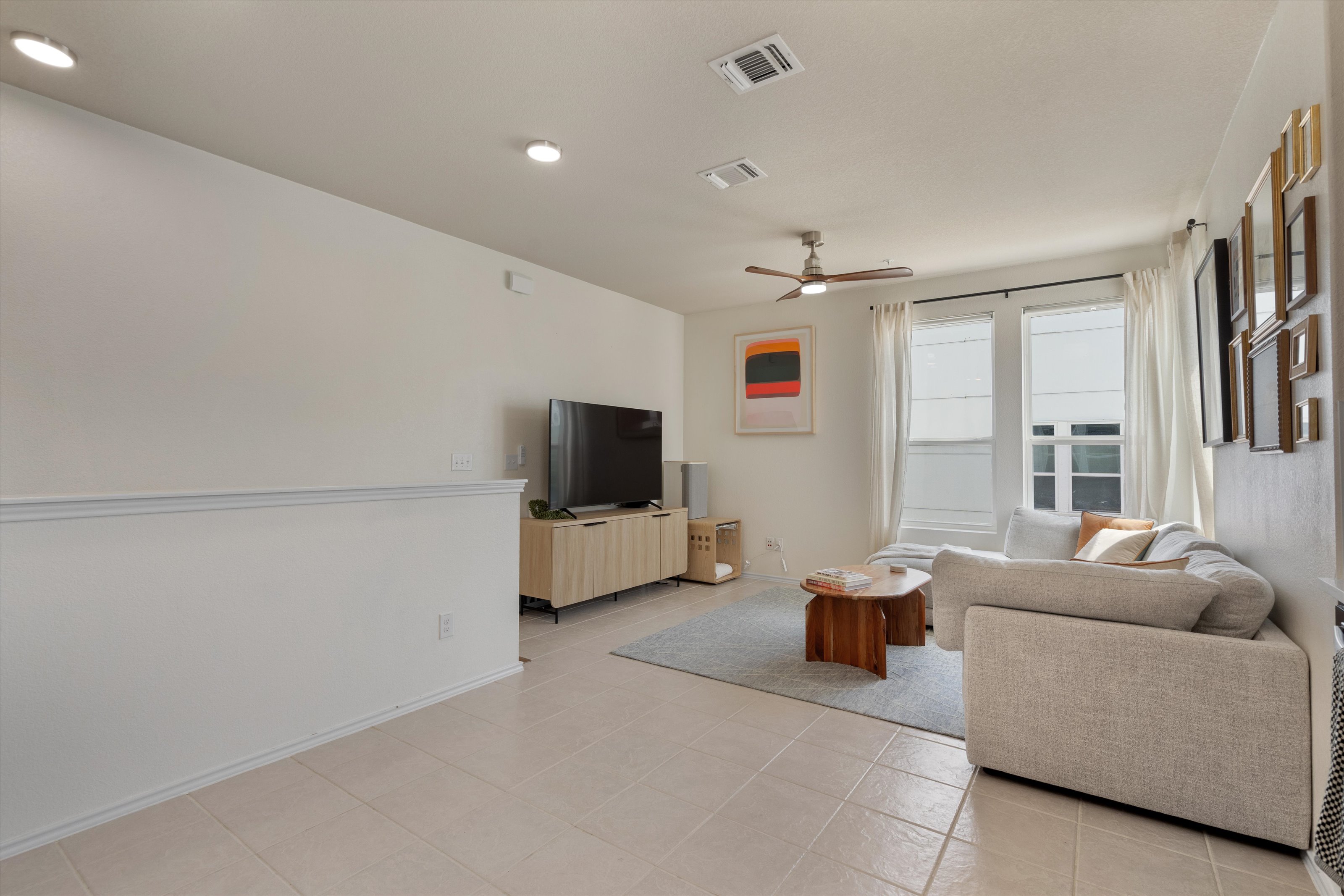 4330 Olenick Street Austin, TX 78723 - Photo 18 of 29 a living room with furniture and a flat screen tv