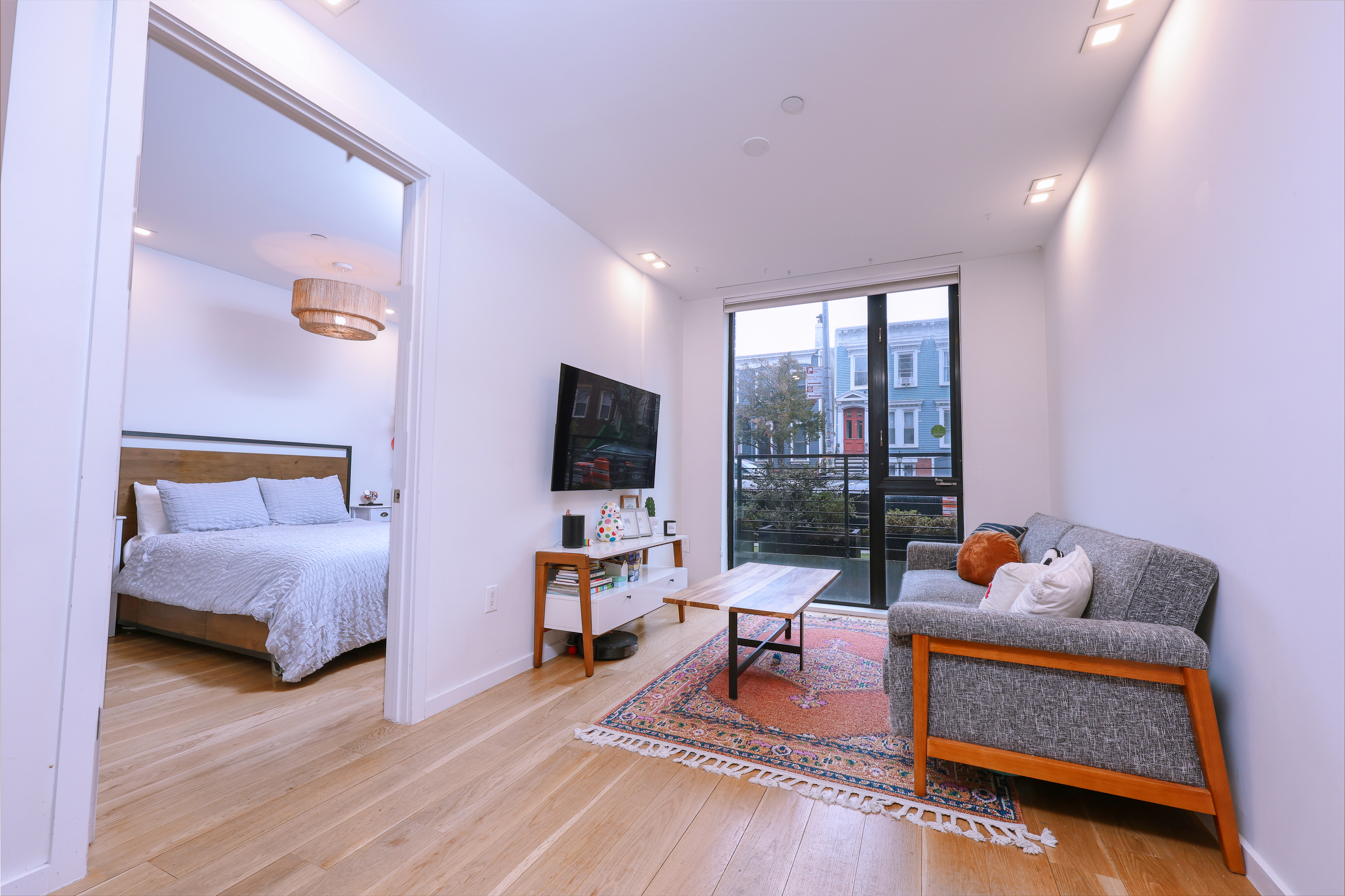 548 Lafayette Avenue, Unit 1A Brooklyn, NY 11205 - Photo 2 of 12 a living room with furniture and a flat screen tv
