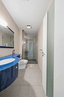 a bathroom with a double vanity sink toilet mirror and bathtub