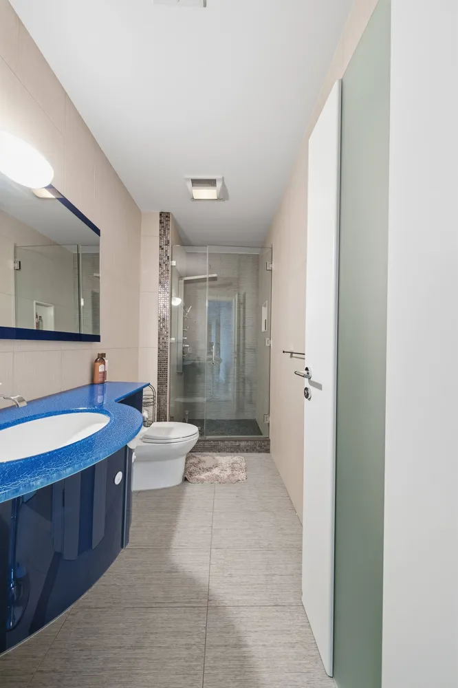 a bathroom with a double vanity sink toilet mirror and bathtub