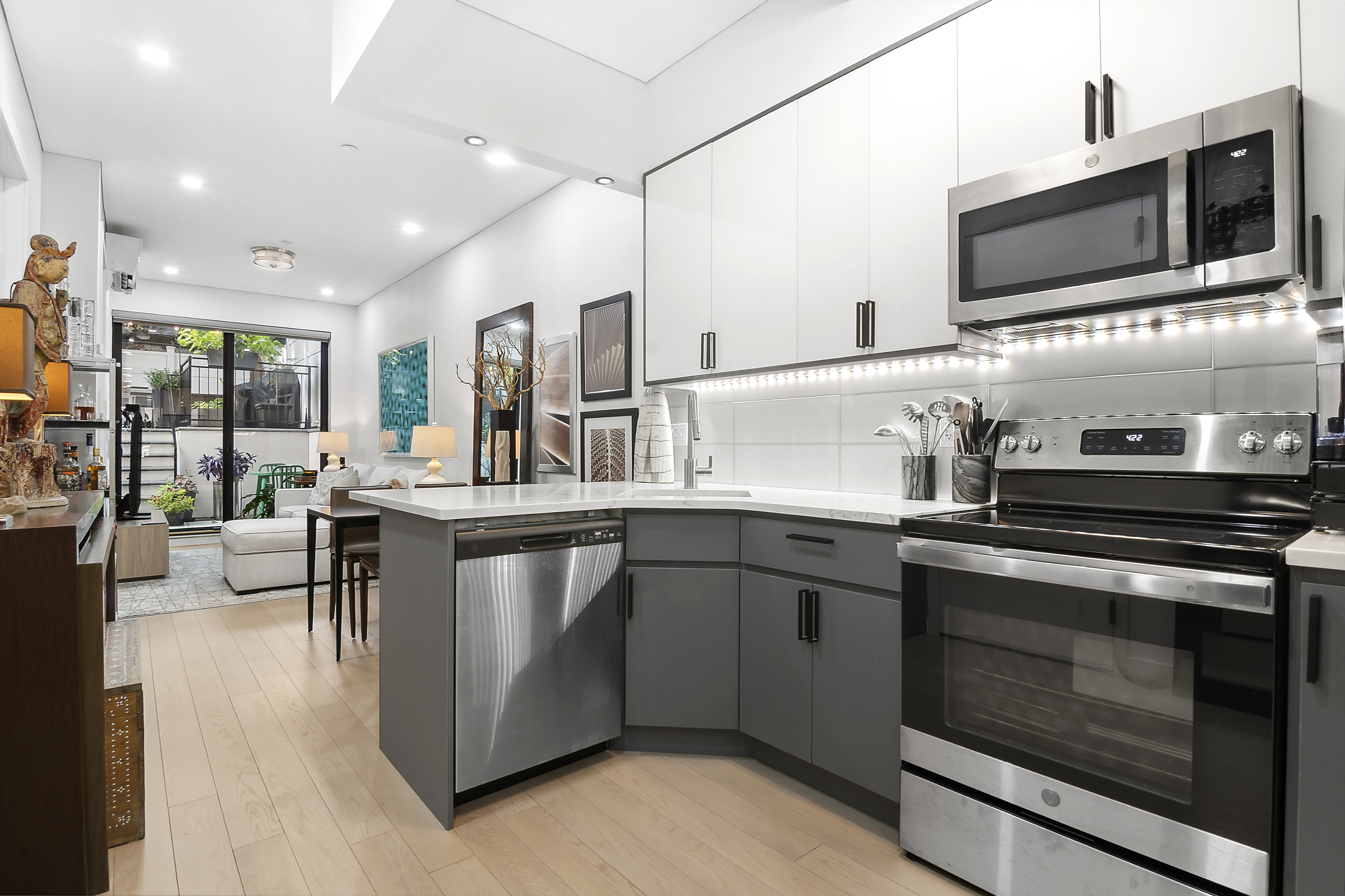 1043 Halsey Street, Unit 1 Brooklyn, NY 11207 - Photo 5 of 14 a kitchen with stainless steel appliances granite countertop a stove and a sink