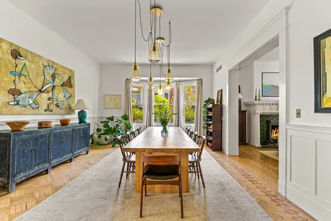 a dining room with furniture and window