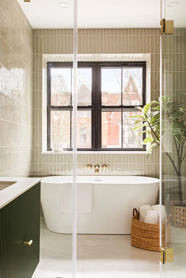 a bathroom with a bathtub and next to a window