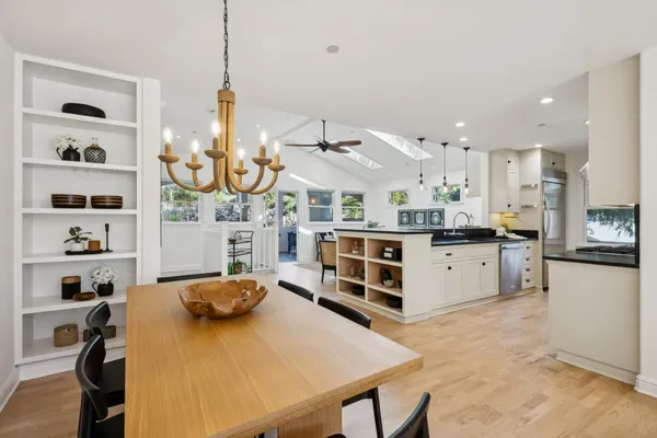 a kitchen with stainless steel appliances granite countertop a sink a stove and a refrigerator