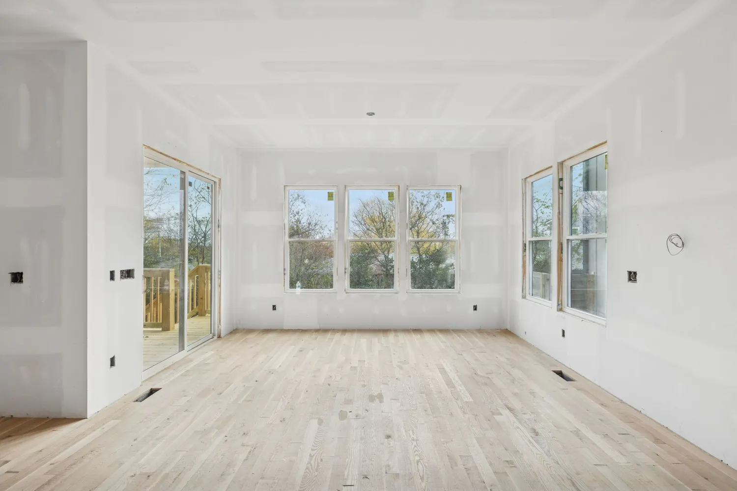 wooden floor in an empty room with a window