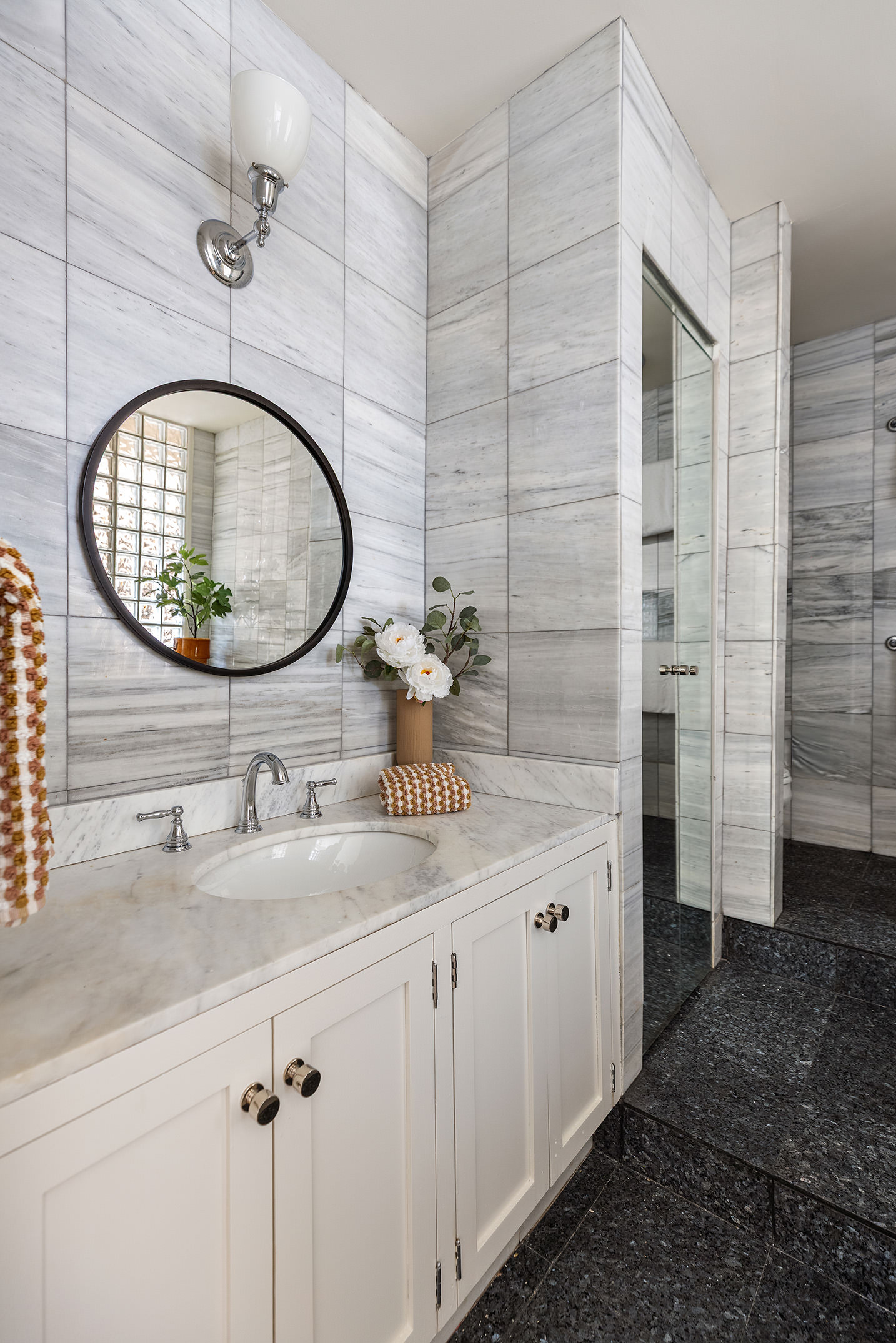 260 West Broadway, Unit 4C Manhattan, NY 10013 - Photo 21 of 28 a bathroom with a granite countertop sink a mirror and shower