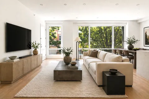 a kitchen with stainless steel appliances a refrigerator sink and cabinets
