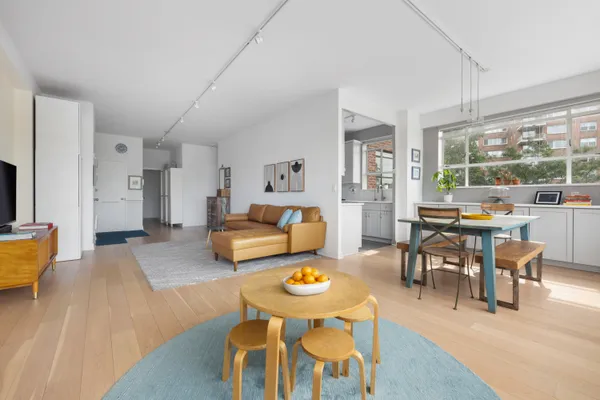 a living room with furniture a rug and a large window