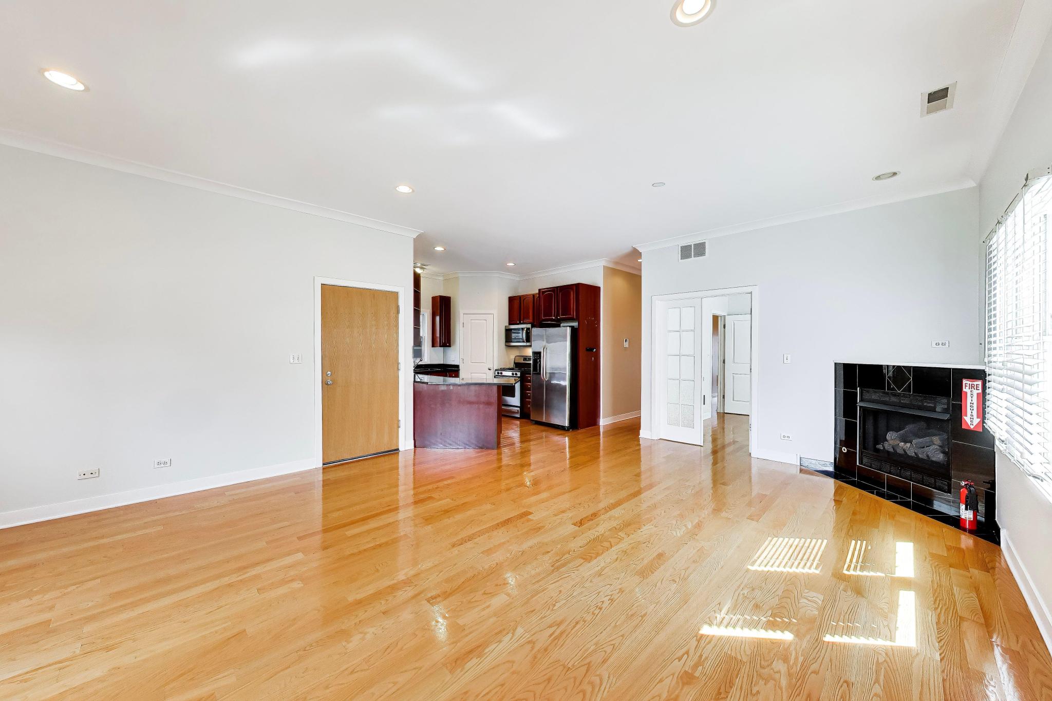 4845 North Springfield Avenue, Unit 2 Chicago, IL 60625 - Photo 6 of 32 a living room with furniture and a flat screen tv