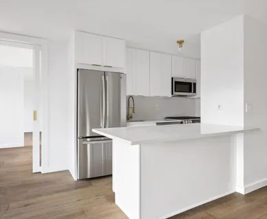 a kitchen with stainless steel appliances a refrigerator and a stove
