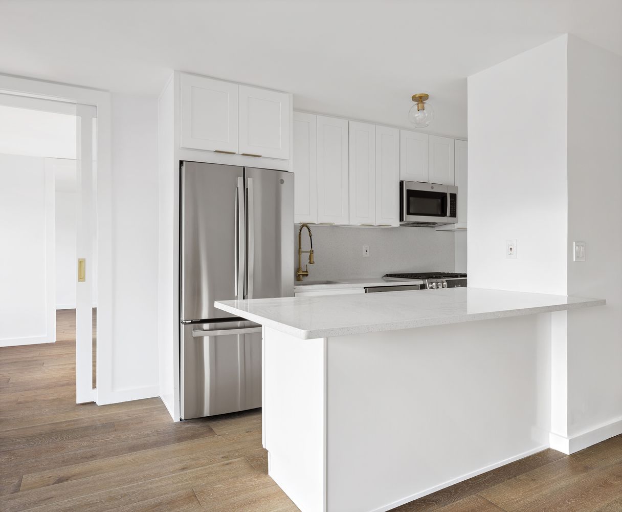 7 East 14th Street, Unit 17RS Manhattan, NY 10003 - Photo 2 of 9 a kitchen with stainless steel appliances a refrigerator and a stove