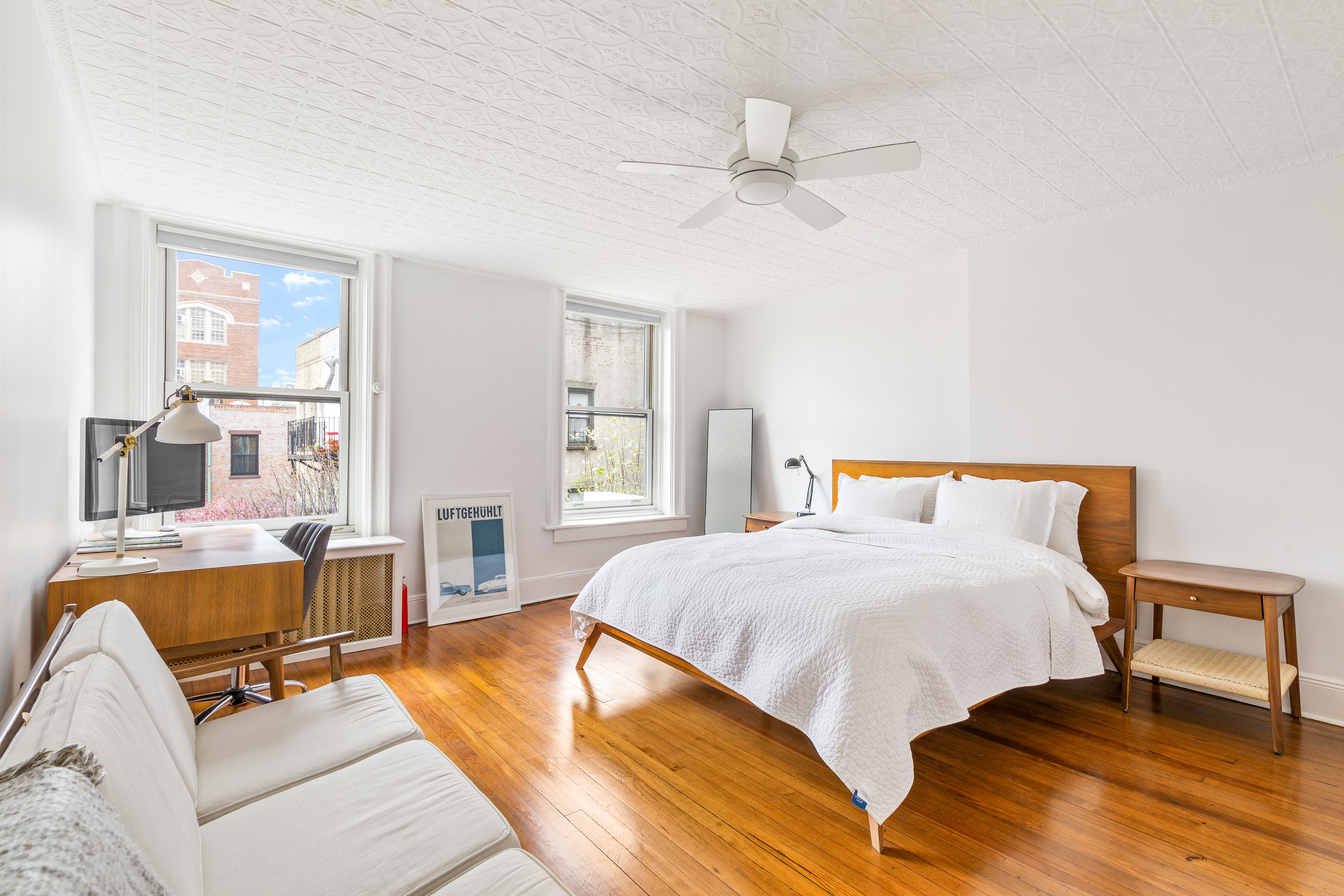 176 Warren Street Brooklyn, NY 11201 - Photo 7 of 13 a bedroom with a bed and wooden floor