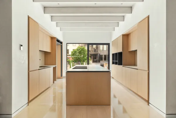 a kitchen with stainless steel appliances a refrigerator and a window