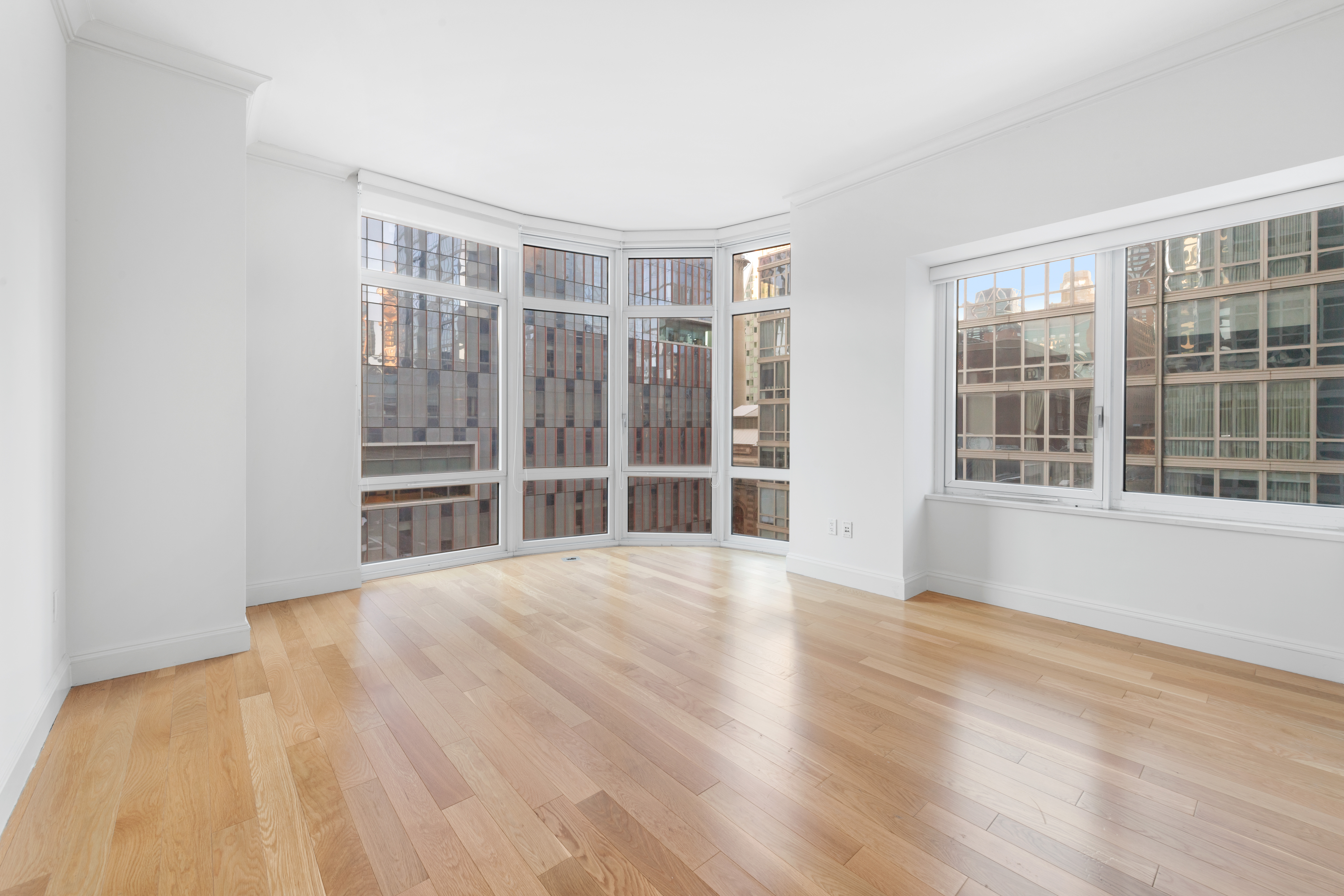 555 West 59th Street, Unit 8B Manhattan, NY 10019 - Photo 5 of 14 a view of an empty room with wooden floor and a window
