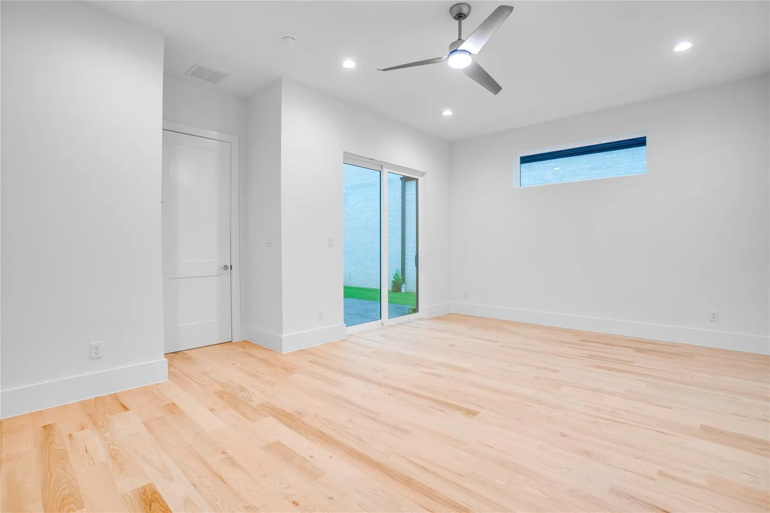 a view of empty room with wooden floor