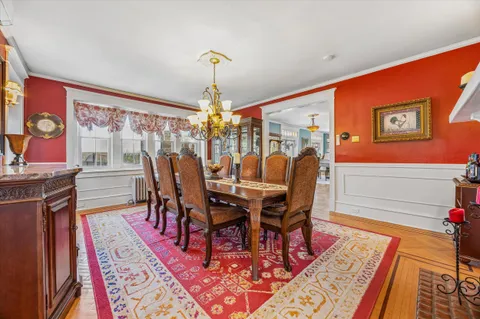 a dining room with furniture and wooden floor