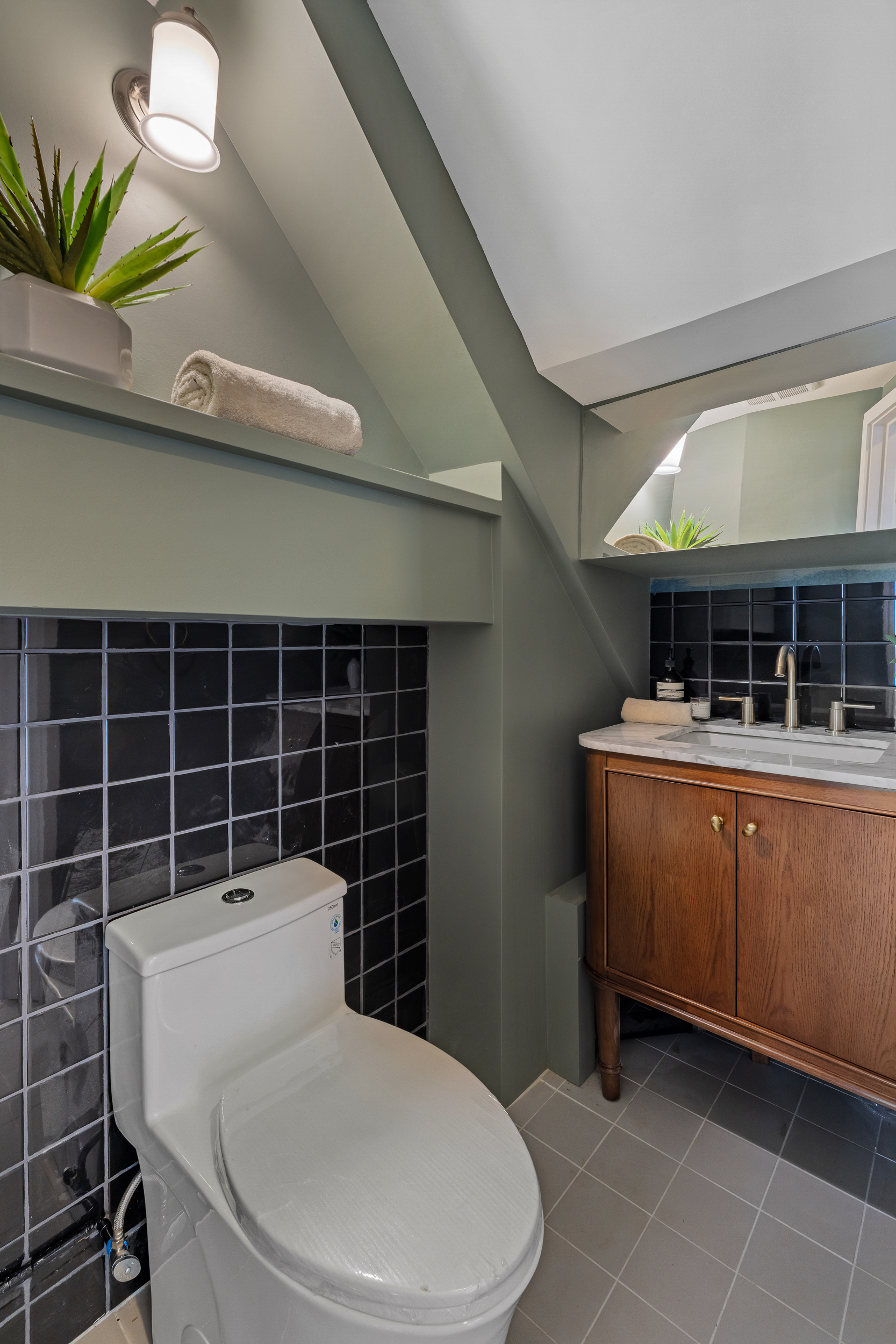 325 Bowery, Unit 3 Manhattan, NY 10003 - Photo 12 of 14 a bathroom with a toilet a sink and mirror