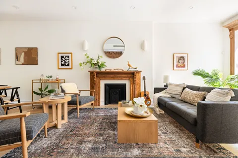 a living room with furniture a fireplace and a table