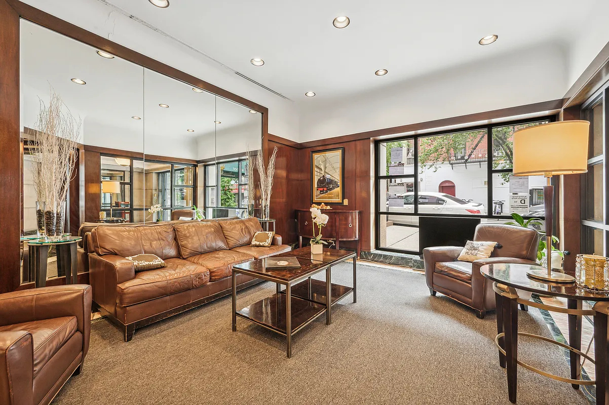 215 West 95th Street, Unit 9J Manhattan, NY 10025 - Photo 7 of 11 a living room with furniture and a large window