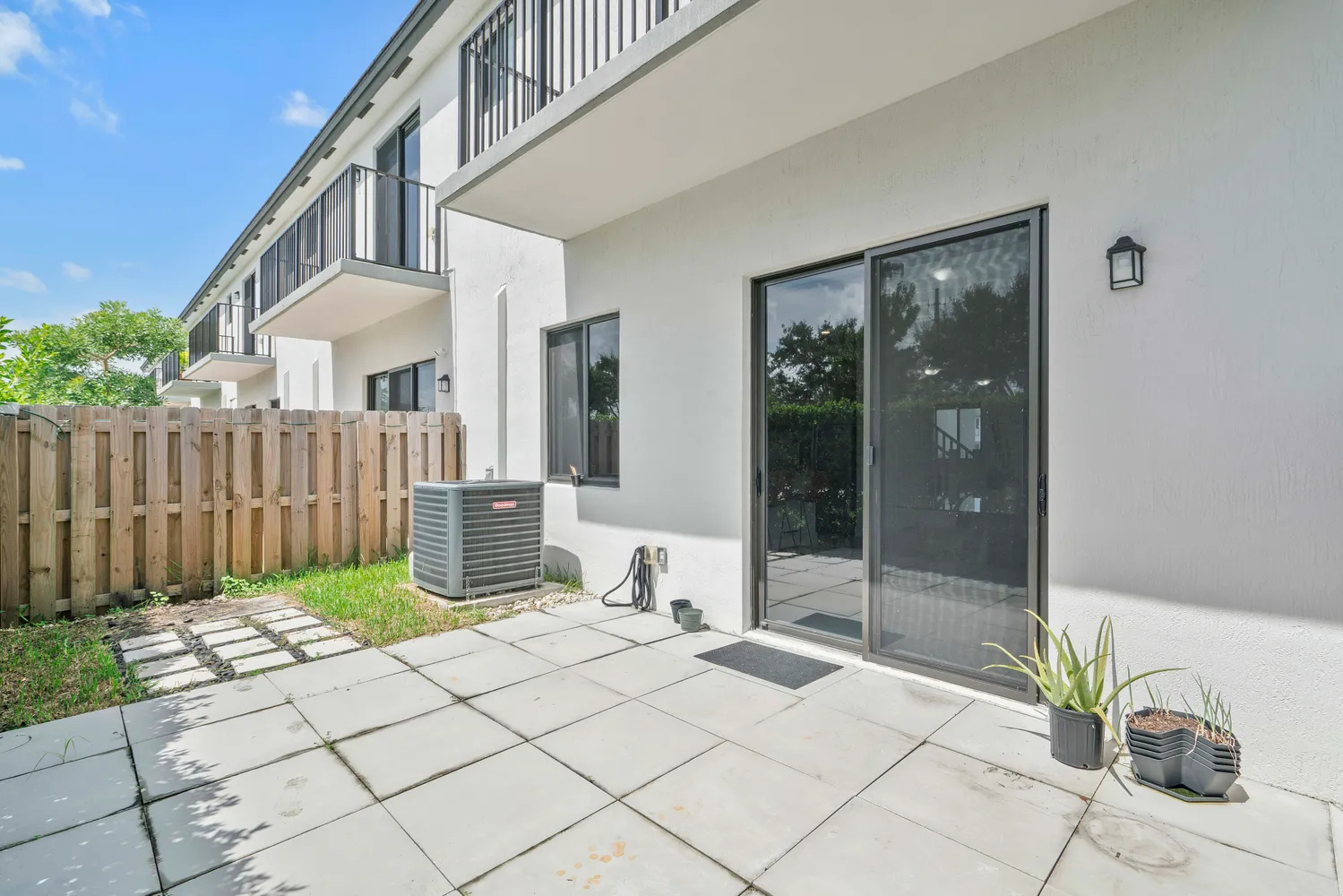 a view of a chair and table in back yard of a house