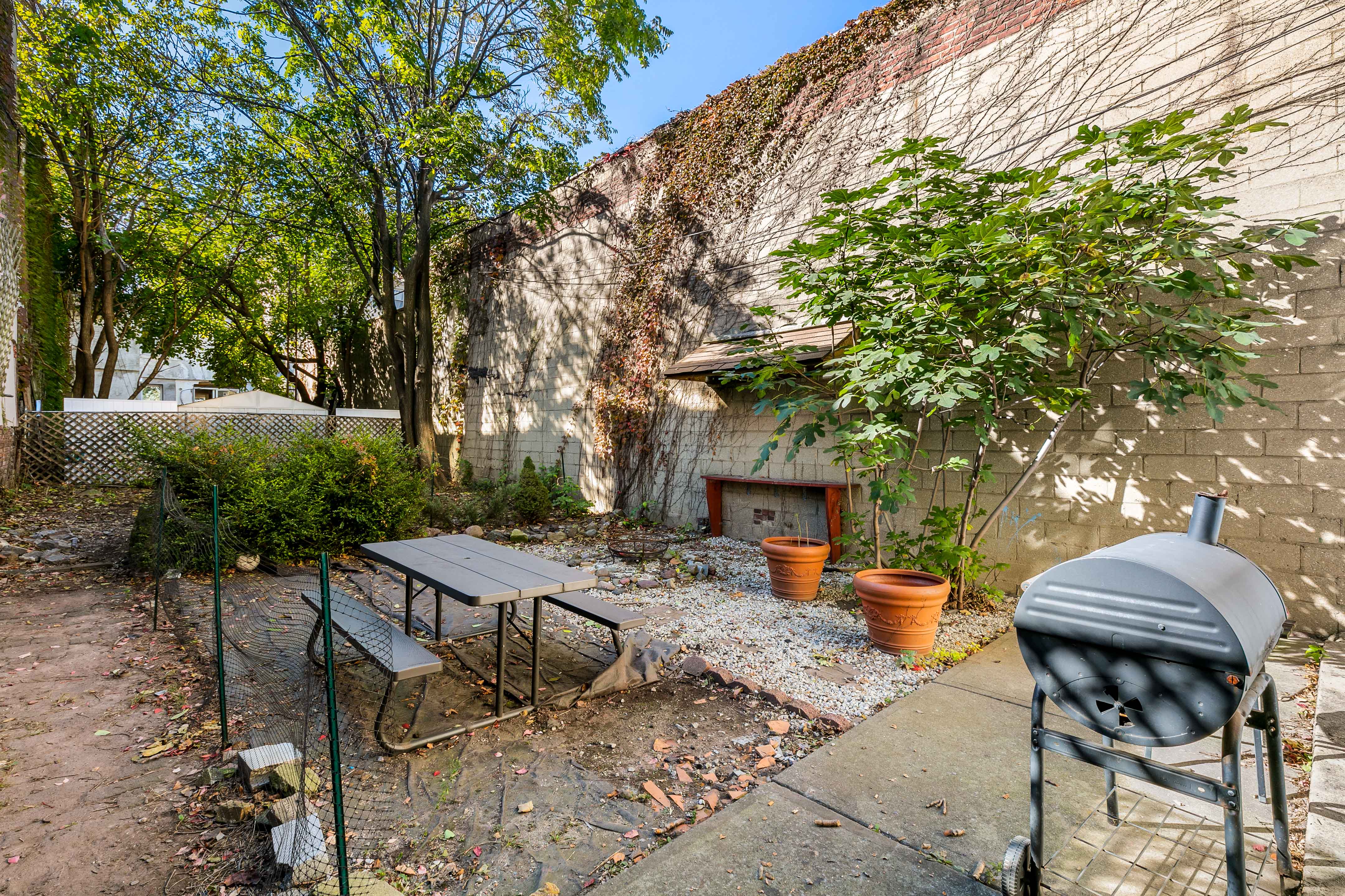 148 29th Street Brooklyn, NY 11232 - Photo 24 of 31 a view of a patio with table and chairs and potted plants