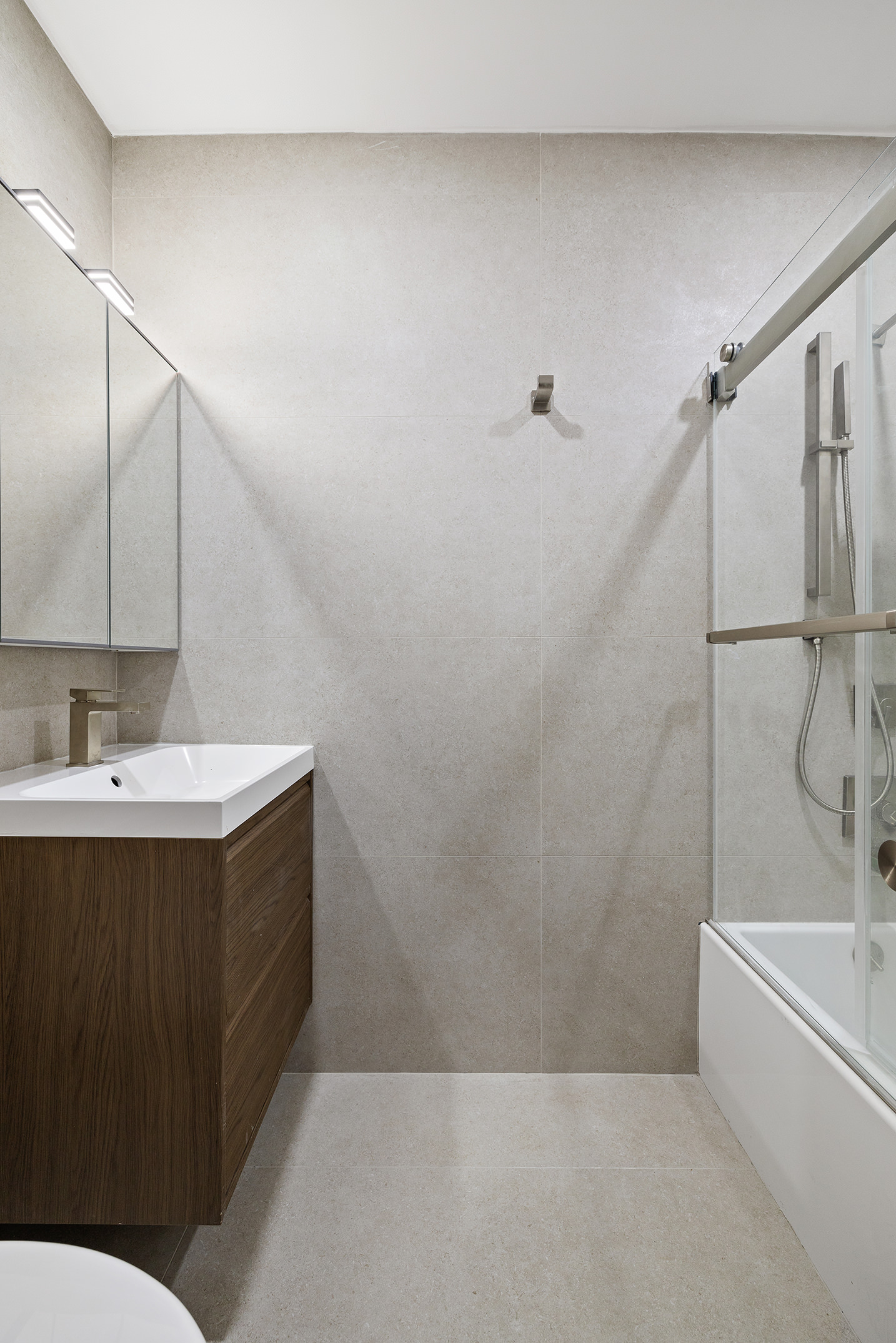 1671 8th Avenue, Unit 1L Brooklyn, NY 11215 - Photo 4 of 7 a bathroom with a sink mirror toilet and bathtub