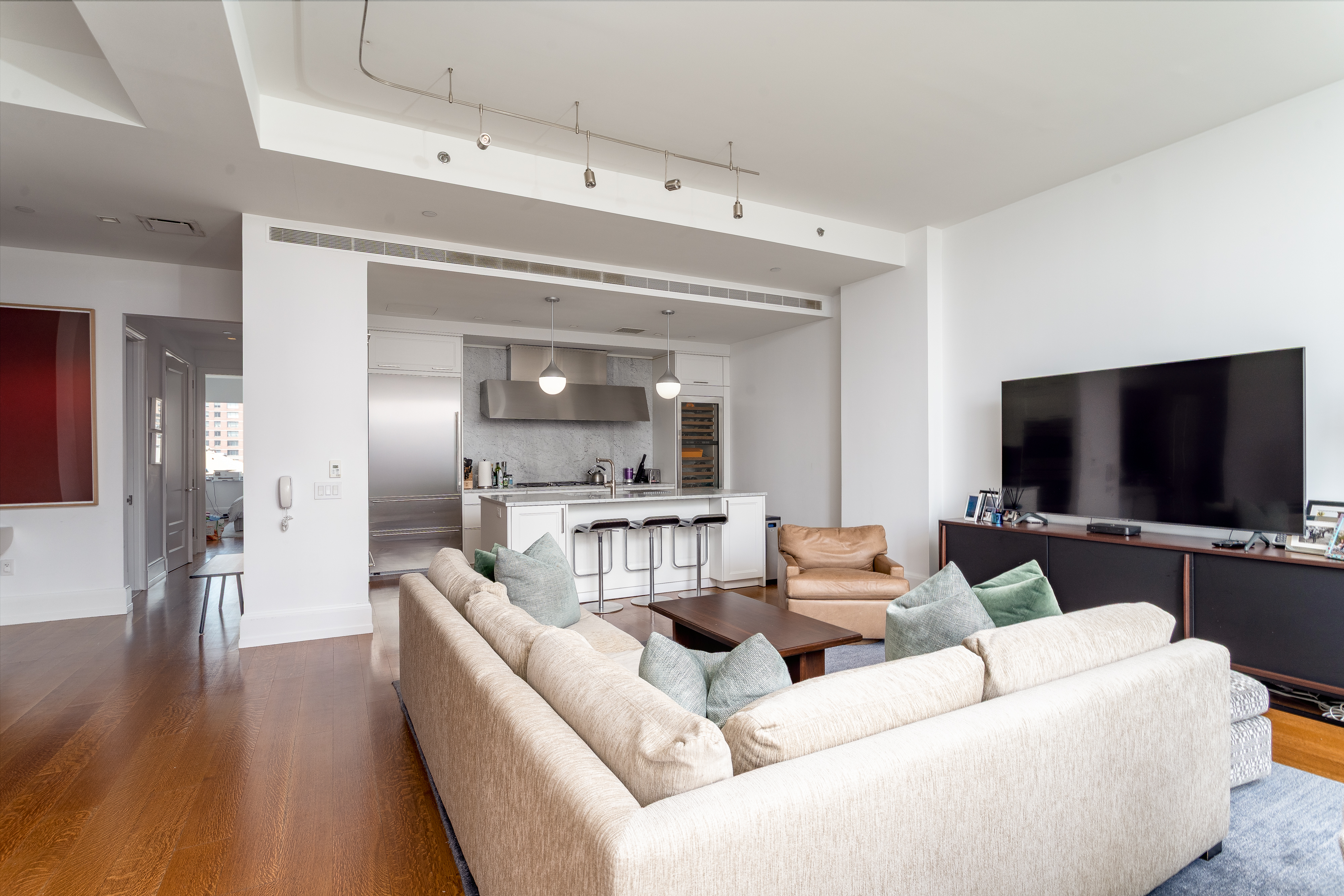 10 Madison Square West, Unit 16F Manhattan, NY 10010 - Photo 5 of 15 a living room with furniture and a flat screen tv