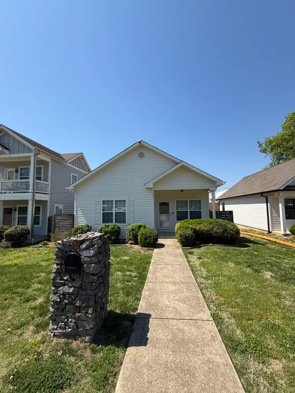 a front view of house with yard having outdoor seating