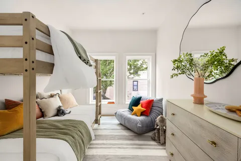 a living room with furniture flowerpot and wooden floor