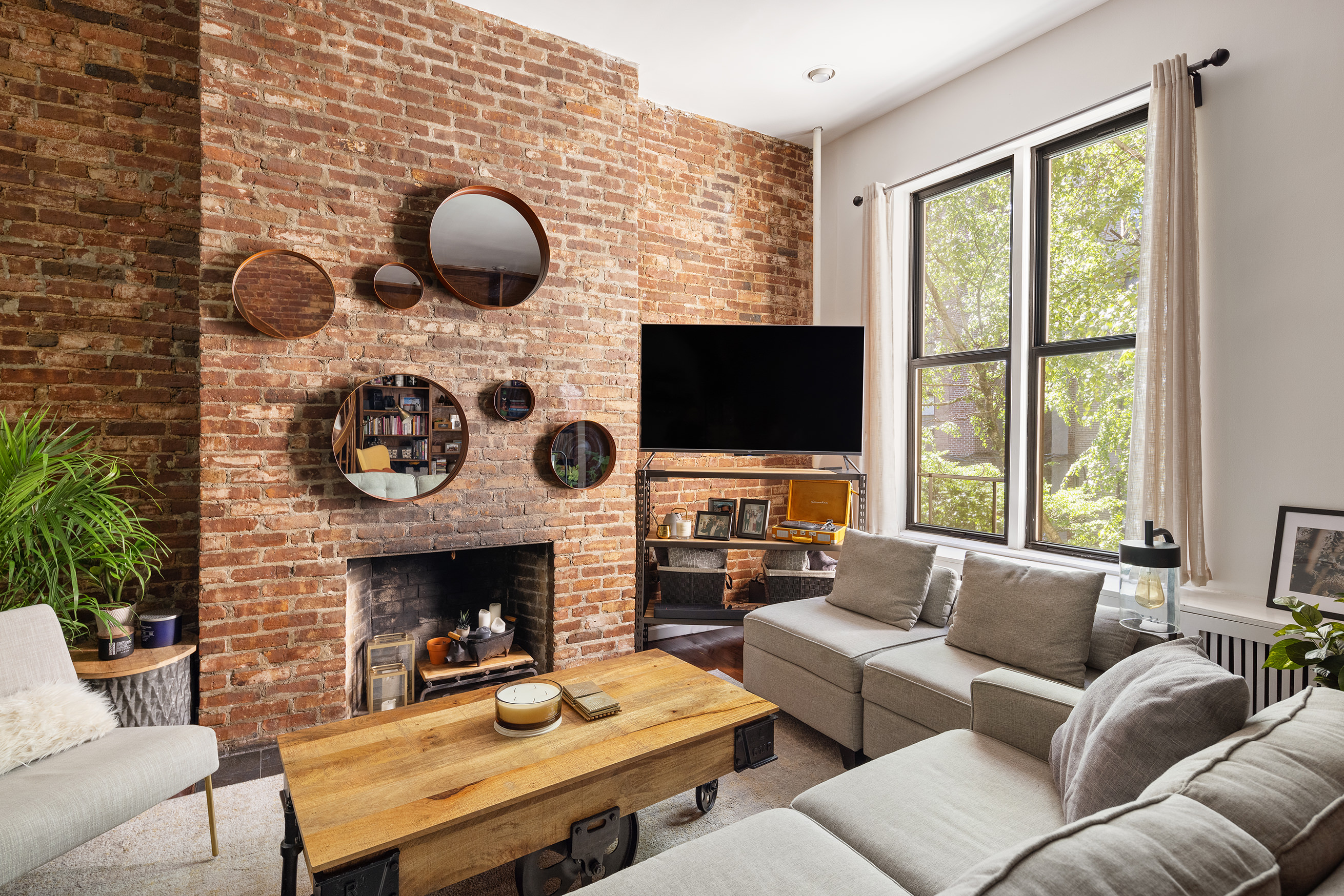 144 West 80th Street Manhattan, NY 10024 - Photo 13 of 22 a living room with furniture a fireplace and a flat screen tv
