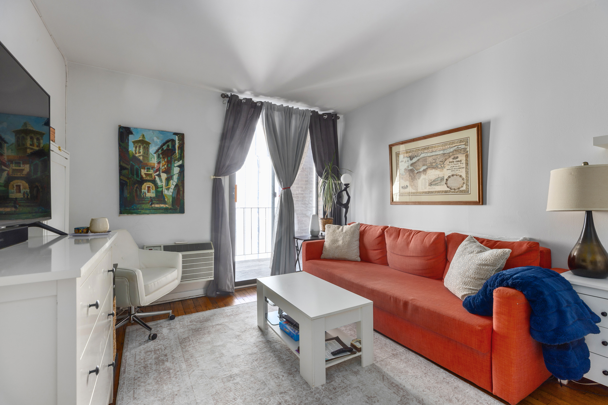 430 East 77th Street, Unit 7C Manhattan, NY 10075 - Photo 2 of 7 a living room with furniture and a window