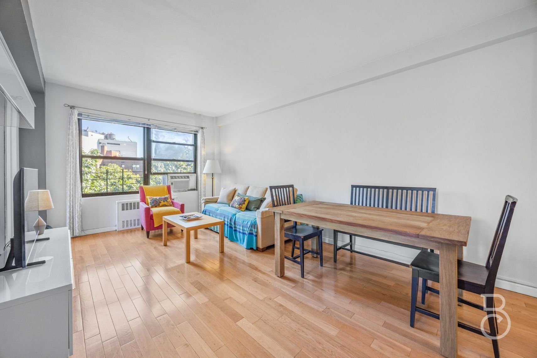 99-52 66th Road, Unit 5D Queens, NY 11374 - Photo 1 of 13 a workspace with furniture hardwood and a window