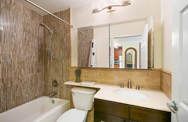 510 East 80th Street, Unit 4D Manhattan, NY 10075 - Photo 13 of 20 a bathroom with a sink and a mirror